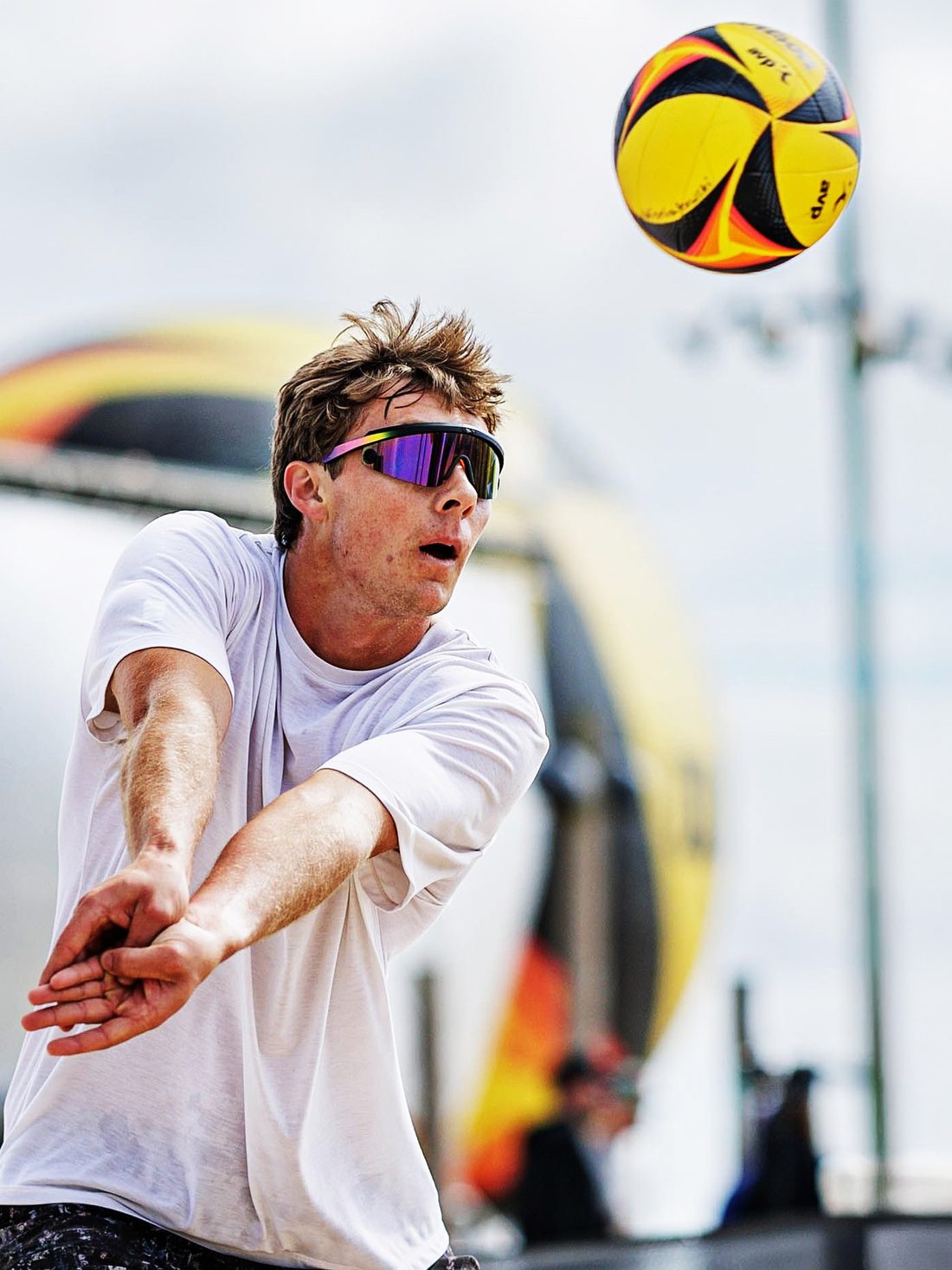 Beach volleyball player passing a ball in deep sand